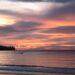 Beautiful sunset over the sea in Phuket, Thailand with colorful clouds and calm water.